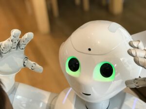 A futuristic humanoid robot with glowing green eyes in a modern setting.